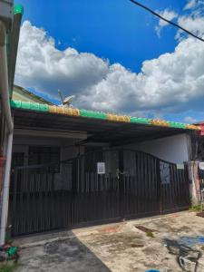 a black gate with a bird sitting on top of it at 571 Seroja Homestay in Sungai Petani