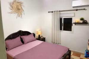 a bedroom with a purple bed and a window at Cozy Host House with 2 air conditioned rooms in Er Rachidia +102 photos