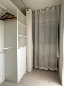 a walk in closet with a shower curtain at A cozy room with ensuite in Springvale, in a shared accommodation in Springvale