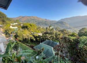 a view of the mountains from a house at Green Lounge in Munnar
