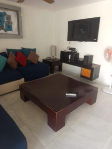 a living room with a couch and a coffee table at Villa en Terrasol Diamante in Acapulco