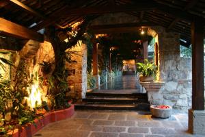 an entrance to a building with plants and stairs at Hotel Museo Spa Casa Santo Domingo in Antigua Guatemala