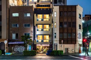 a building on a city street at night at Saikou in Osaka