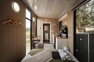 a bedroom with a bed and a large window at Sunset Hill by Tiny Away in Dollar