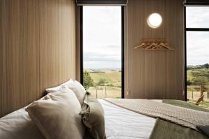 a bedroom with a bed with a large window at Sunset Hill by Tiny Away in Dollar +14 photos