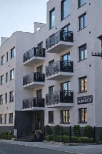 a building with balconies on the side of it at Luxury Apartments Musialika 18 in Bytom