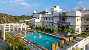 an aerial view of a building with a swimming pool at lebua Udaipur Daulatgarh in Udaipur