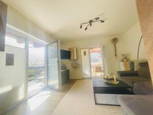 a living room with a couch and a ceiling fan at Apartment WEITBLICK in Wald im Pinzgau