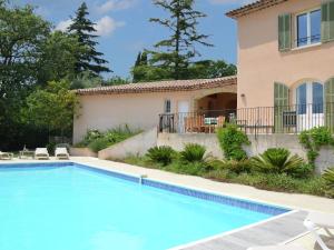 a villa with a swimming pool in front of a house at Modern Villa with Private Pool in Cabris in Cabris