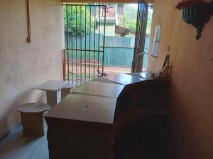 a room with a table and benches and a window at Hotel Silent River in Ingiriya