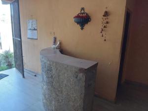 a room with a counter and a wall with a bunch of crosses at Hotel Silent River in Ingiriya