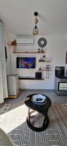 a living room with a coffee table and a tv at Homely studio Apartment 2 in Mombasa