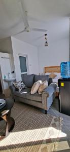 a living room with a couch and a table at Homely studio Apartment 2 in Mombasa