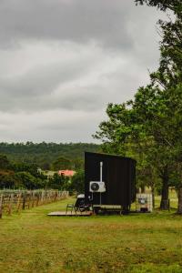 a stage with a screen in a field at Sunset Tiny House at Bluebush Estate X by Tiny Away in Rothbury