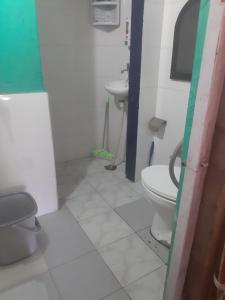 a bathroom with a toilet and a sink at Rahul Residency Homestay- Couple & Family friendly- 'prime location- Easy access to Mall Rd- WiFi- Smart TV - Kitchen- City view in Solan +9 photos