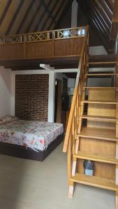 a bedroom with a bunk bed and a staircase at Qinoz Villaz in Kedungwaru