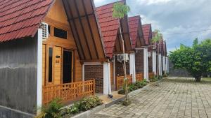a row of houses with red roofs on a street at Qinoz Villaz in Kedungwaru