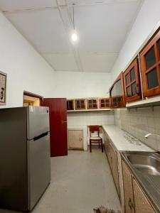 an empty kitchen with a sink and a refrigerator at Alex s Cottage in Kandy