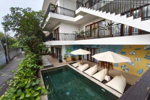 an apartment with a swimming pool and a building at Home 21 Bali in Sanur +36 photos