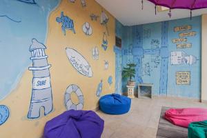 a room with a wall with drawings on it at Home 21 Bali in Sanur