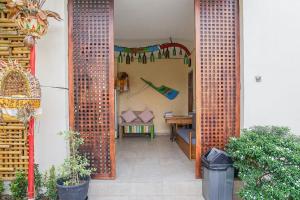an entrance to a room with a desk and a table at Home 21 Bali in Sanur