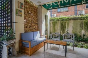 a patio with a couch and a table and chairs at Home 21 Bali in Sanur