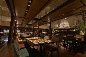 a restaurant with tables and chairs with a chessboard at Kyoto Century Hotel in Kyoto +100 photos