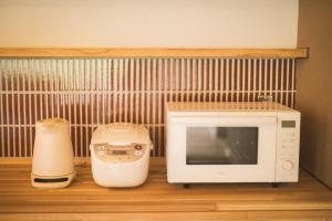 a kitchen with a microwave and a blender at 比地の宿 in Kunigami