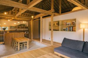 a living room with a blue couch and a table at 比地の宿 in Kunigami +22 photos