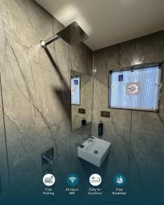 a bathroom with a sink and a shower at The Premier, Dwarka in Dwarka