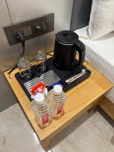 a coffee table with a tea kettle and glasses on it at The Premier, Dwarka in Dwarka