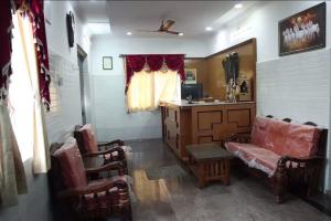 a living room with a couch and a table at R R Paradaise in Pūtalapattu