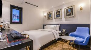 a bedroom with a bed and a desk and a computer at MARI hotel in Incheon