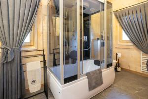 a glass shower in a room with curtains at Osada Poronin in Poronin +19 photos