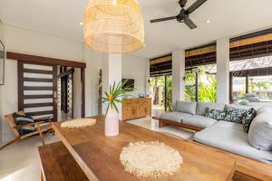 a living room with a couch and a table at Fraser Baye Villas in Uluwatu