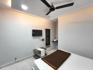 a bedroom with a bed and a flat screen tv at Hotel Rudra in Wākal