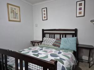 a bedroom with a bed and pillows on it at The Garden view Nook in Ash