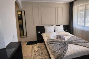 a bedroom with a bed with a bow on it at Pensiunea Clasic in Buşteni