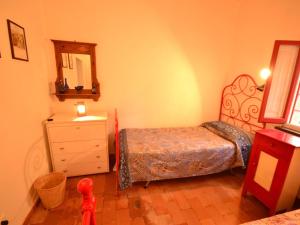 A bed or beds in a room at Holiday Home in Tuscany near Abetone Ski Lift