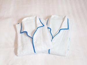 three white socks sitting on a bed at Comfort Hotel Suzuka in Suzuka