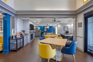 a dining room with a table and yellow chairs at Comfort Inn West Monroe near Sports & Events Center in West Monroe