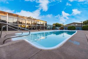 a swimming pool in front of a building at Suburban Studios Canon City in Canon City