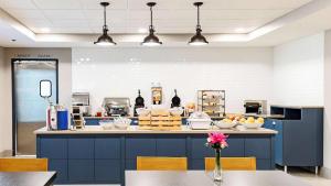 a kitchen with a counter with bowls of food at Country Inn & Suites by Radisson, Appleton Airport - Fox River Mall Area in Appleton