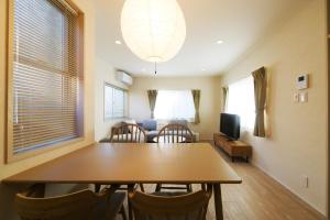 a dining room with a table and chairs and a couch at JAPANDI HOTEL Nagoya in Chikusachō +33 photos