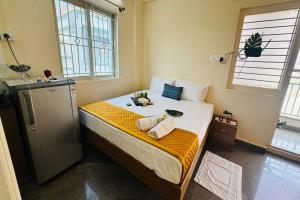 a bedroom with a bed with two towels on it at Visaara Luxury Homes in Kammasandra +55 photos