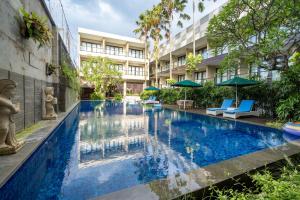 a swimming pool in the middle of a building at Dekuta in Kuta