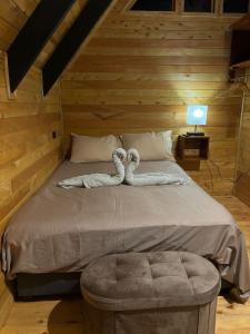 a large bed in a wooden room with a bedvisor at Brisas De Los Santos Lodge 1 in Sierra