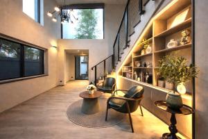 a hallway with two chairs and a table in a house at Vantara Private Villa Chiang Mai in Chiang Mai