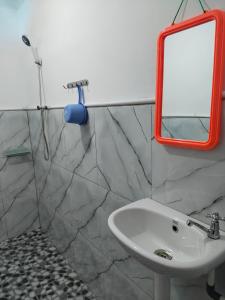 a bathroom with a sink and a mirror at EL Homestay Bunaken in Bunaken +87 photos