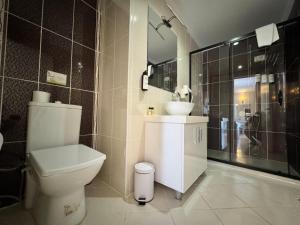 a bathroom with a toilet and a sink and a shower at Villa Vanilla Hotel in Istanbul +25 photos